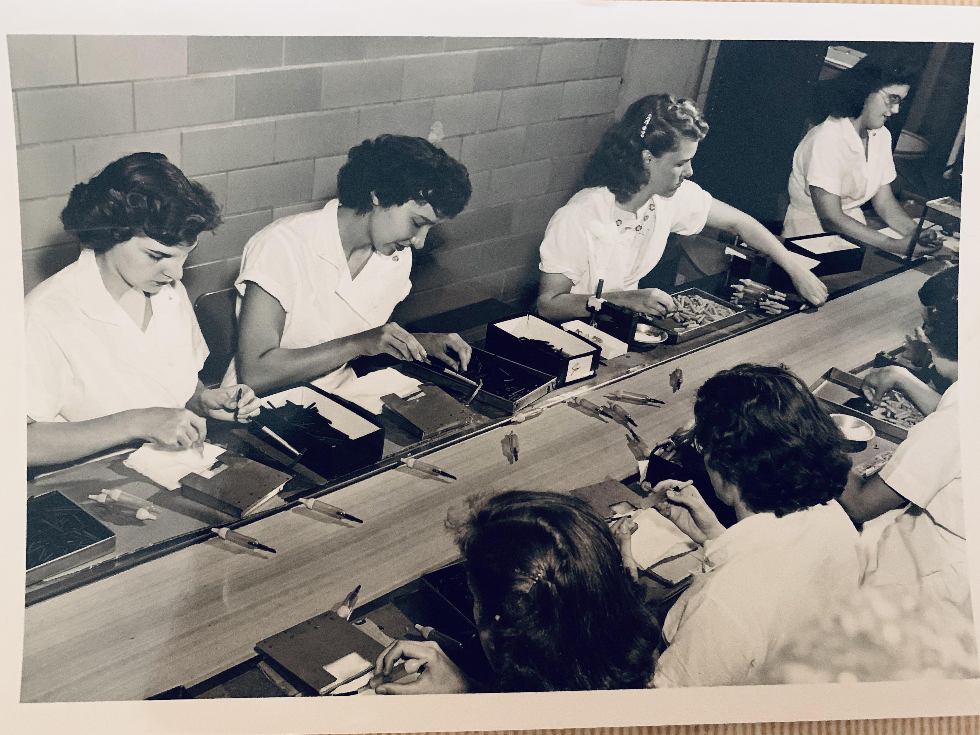 Assembly line workers, many women, operated heavy presses with little protection.